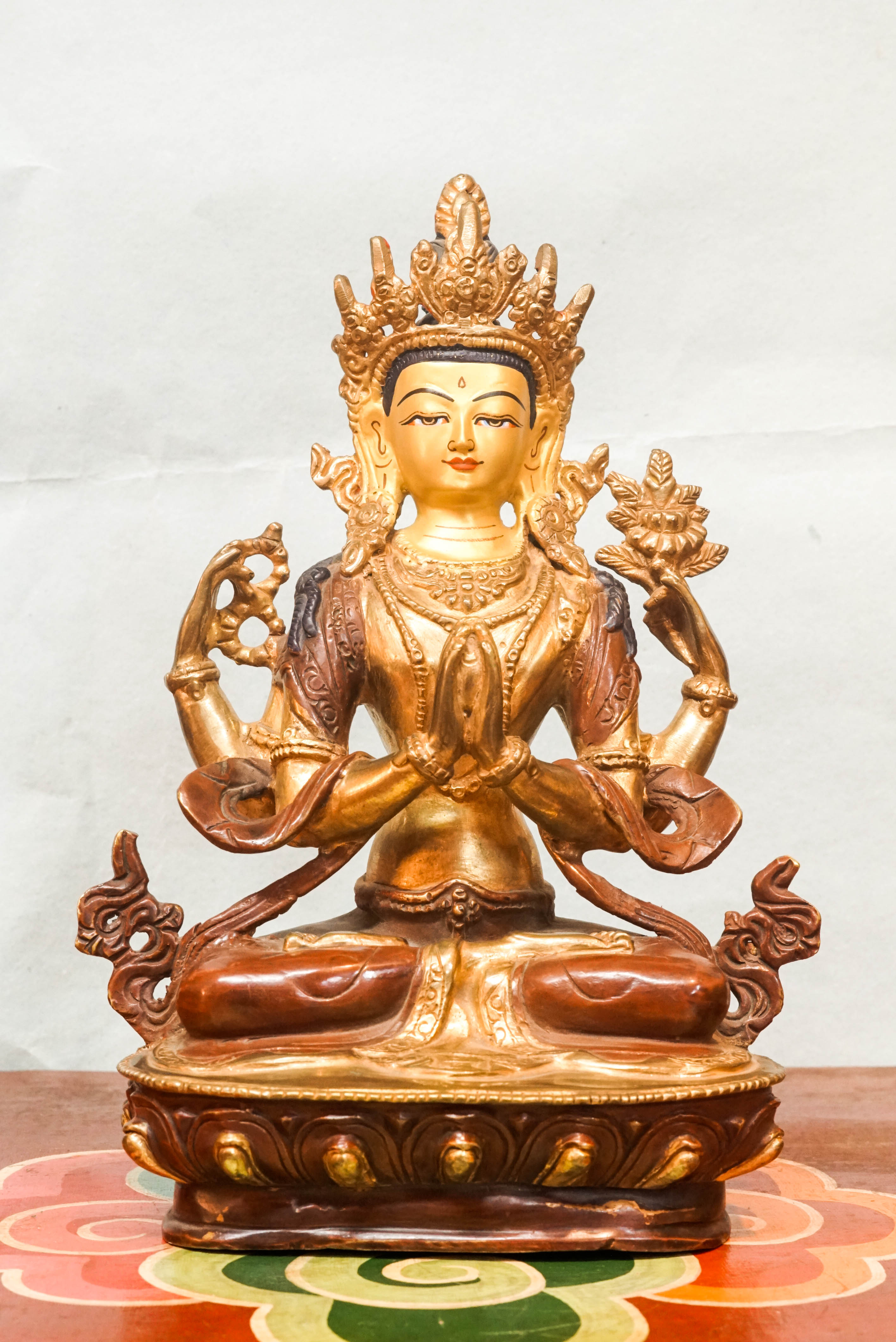 Chenrezig statue depicts the Bodhisattva of Compassion in four-armed form seated on a lotus pedestal. Ideal for meditation altars or spiritual decor, it inspires mindfulness, healing, and heartfelt compassion in any space.