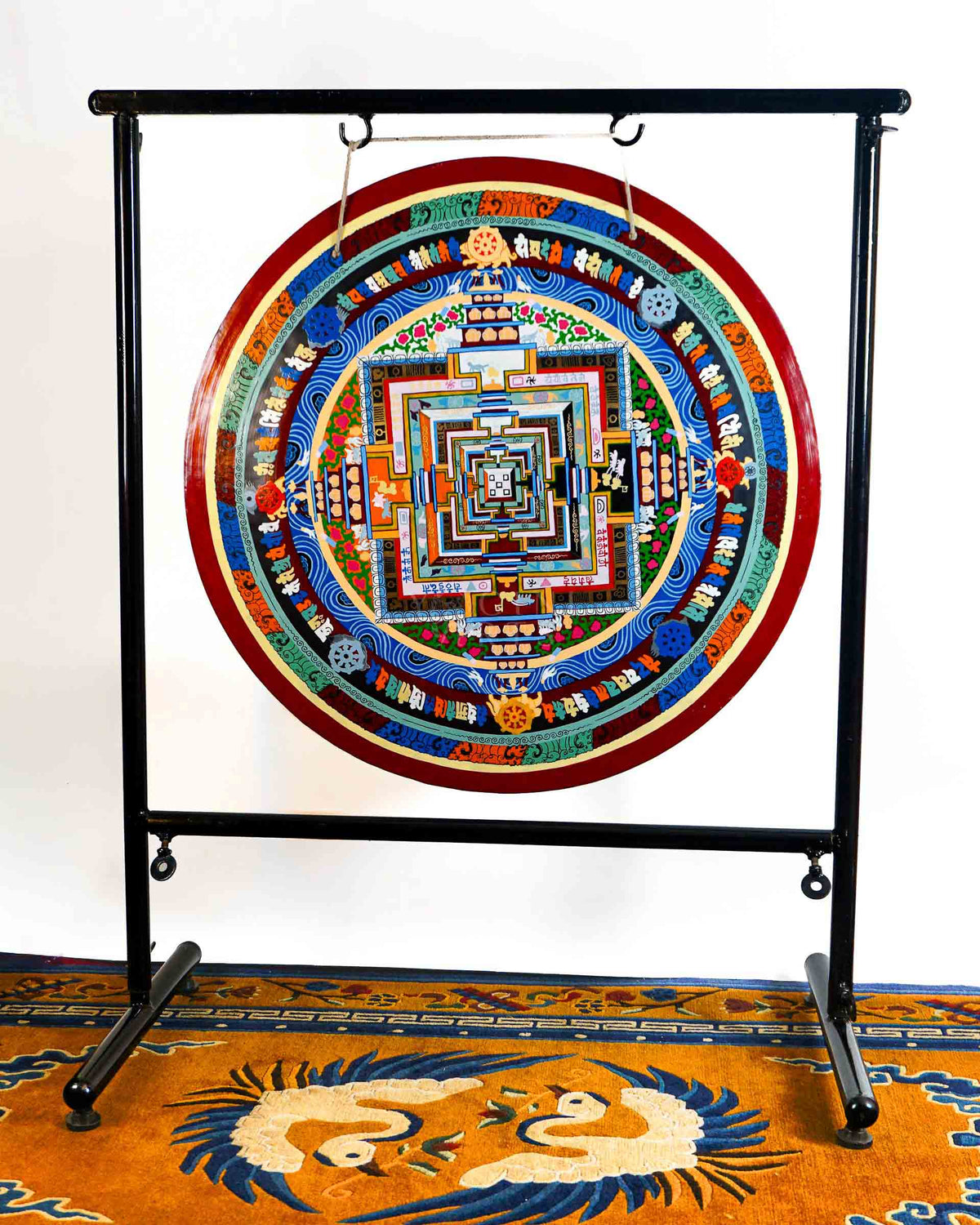 Kalachakra Mandala gong featuring colorful sacred geometry, Tibetan script, Buddhist symbols, and traditional Nepalese artwork