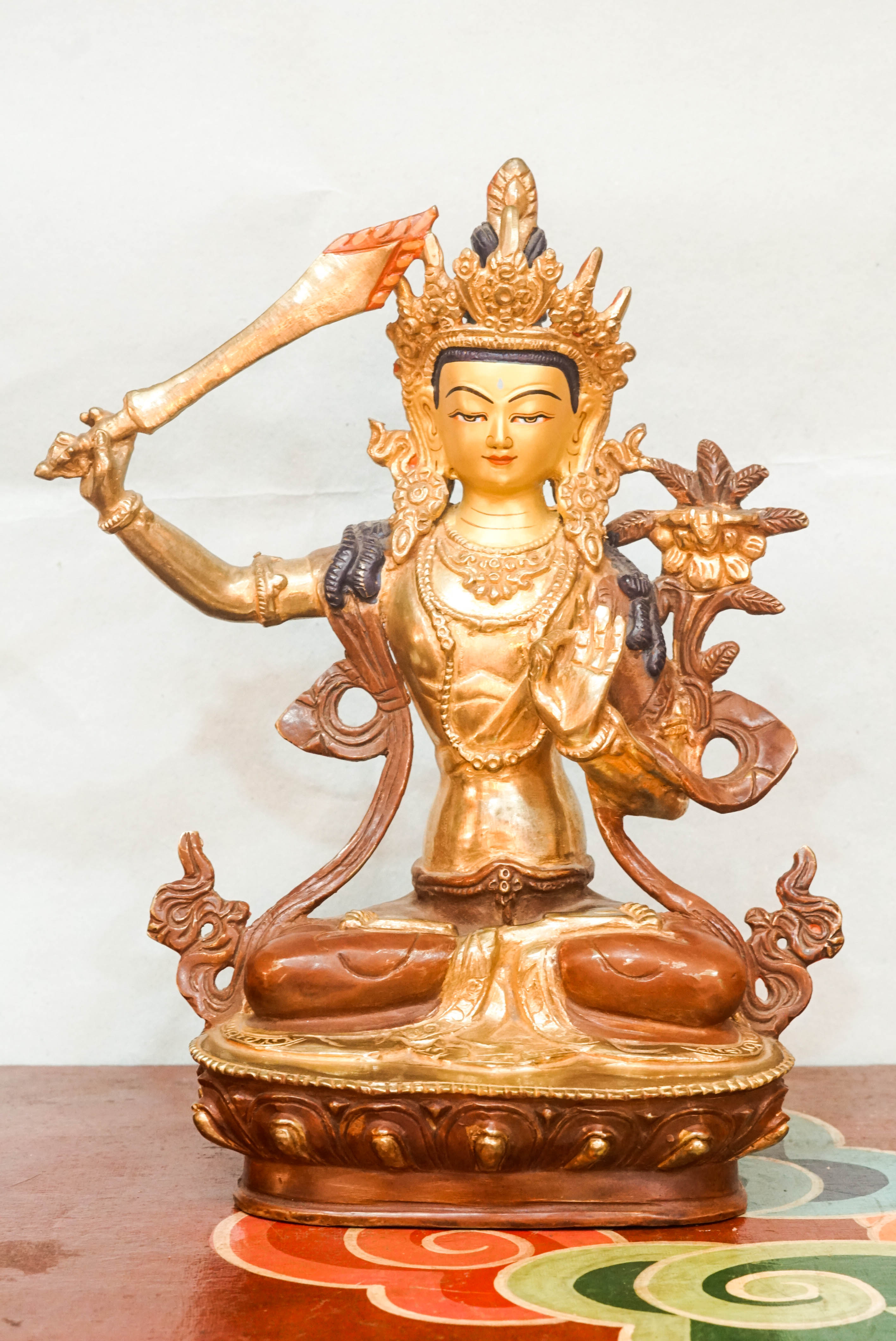 Manjushri statue symbolizes wisdom and enlightenment. Featuring a flaming sword and sacred scripture, it is perfect for meditation altars or home. It inspires clarity, spiritual growth, and mental sharpness.