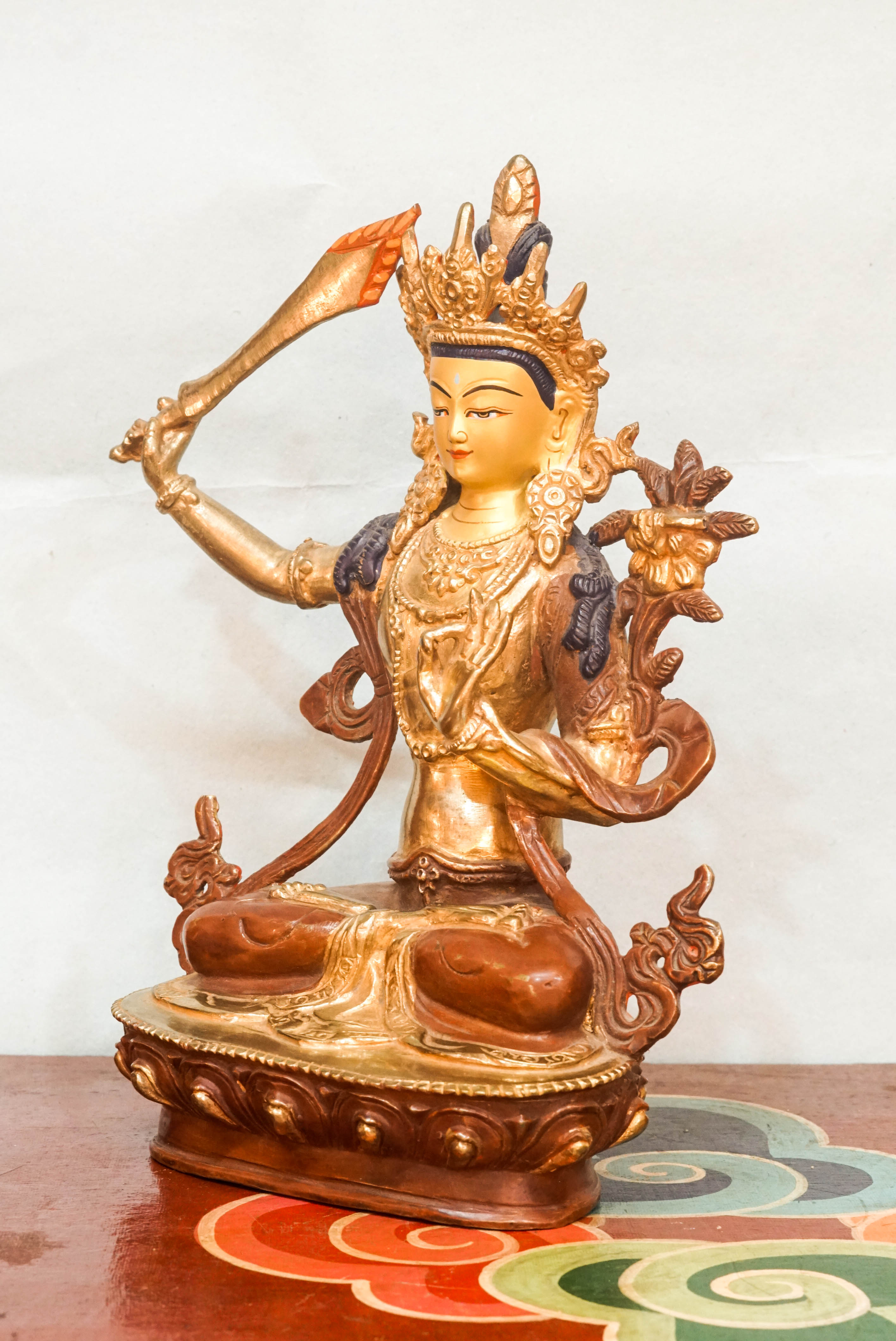 Manjushri statue symbolizes wisdom and enlightenment. Featuring a flaming sword and sacred scripture, it is perfect for meditation altars or home. It inspires clarity, spiritual growth, and mental sharpness.