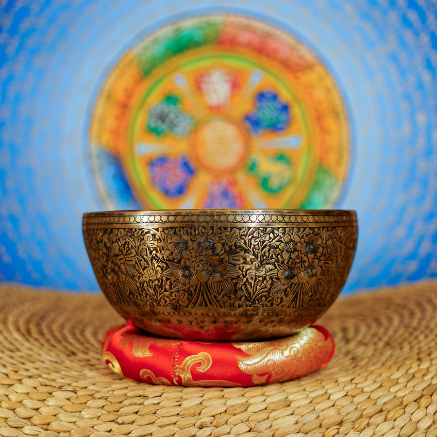 Semi antique handmade singing bowl with intricate floral engravings and aged bronze finish from Nepal