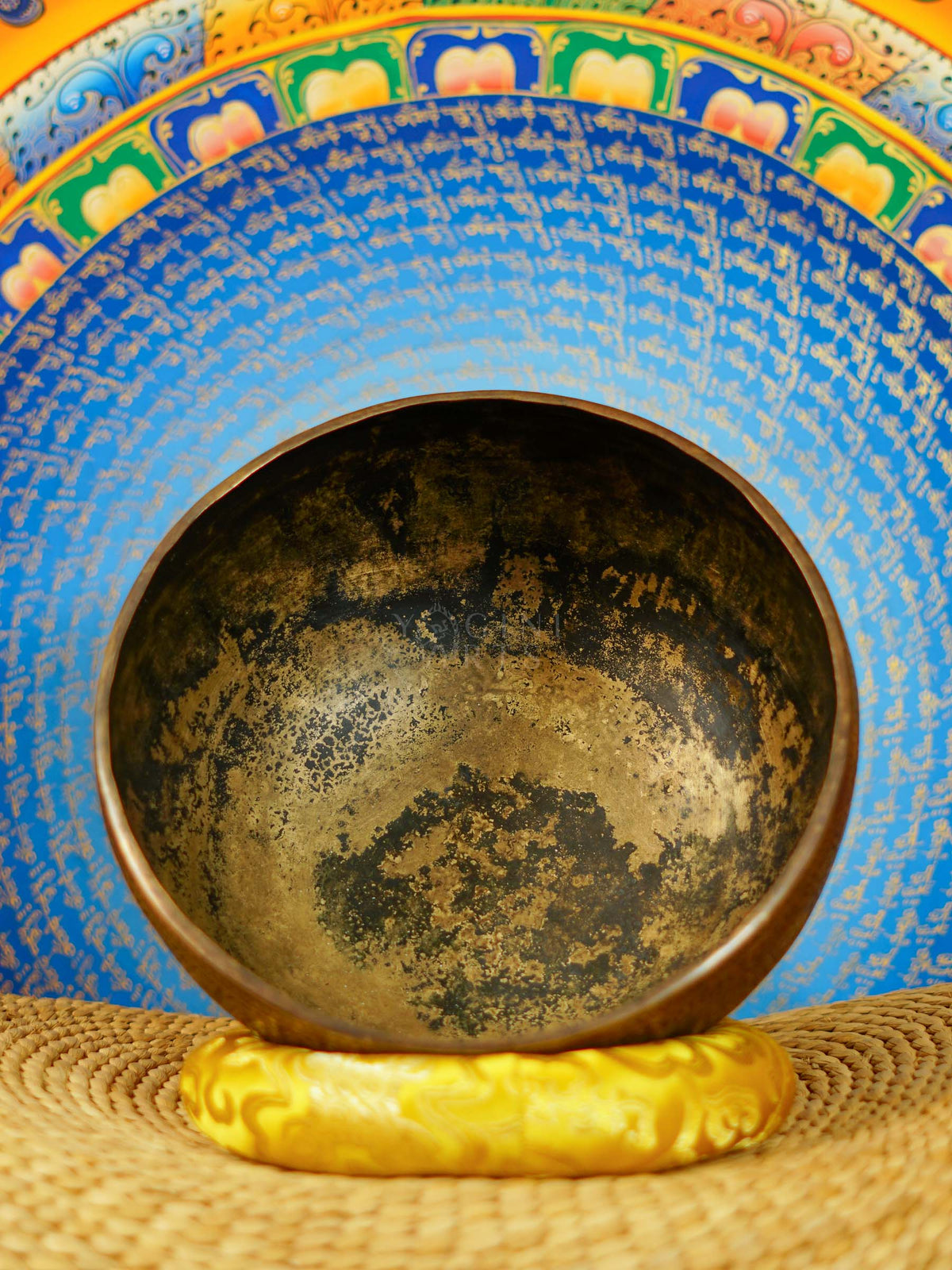 Semi antique handmade singing bowl with intricate flower vase engraving and floral patterns on aged bronze