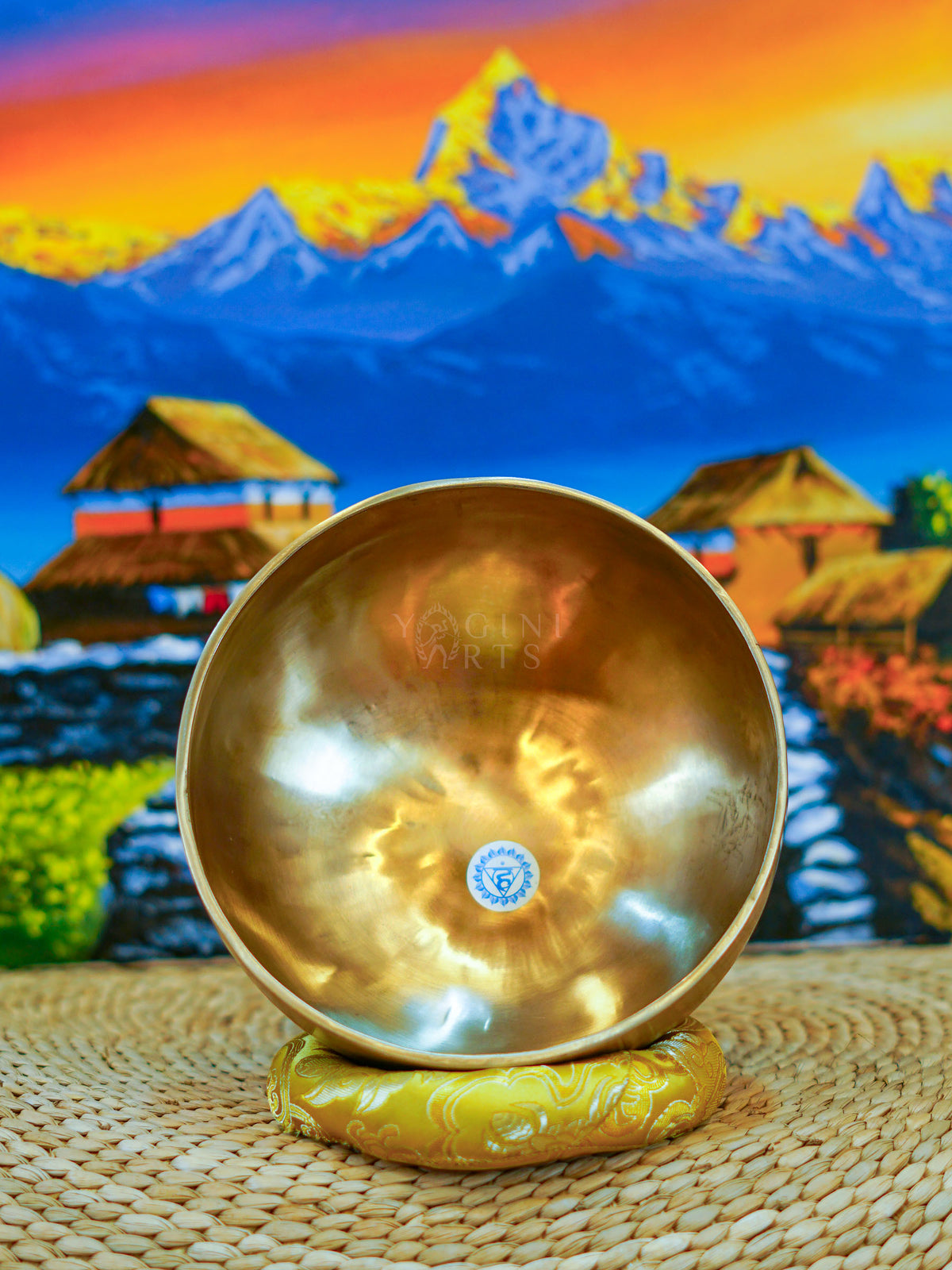 Seven handcrafted Himalayan singing bowls arranged together, showing graduated sizes, chakra symbols, and warm antique bronze-gold finishes.