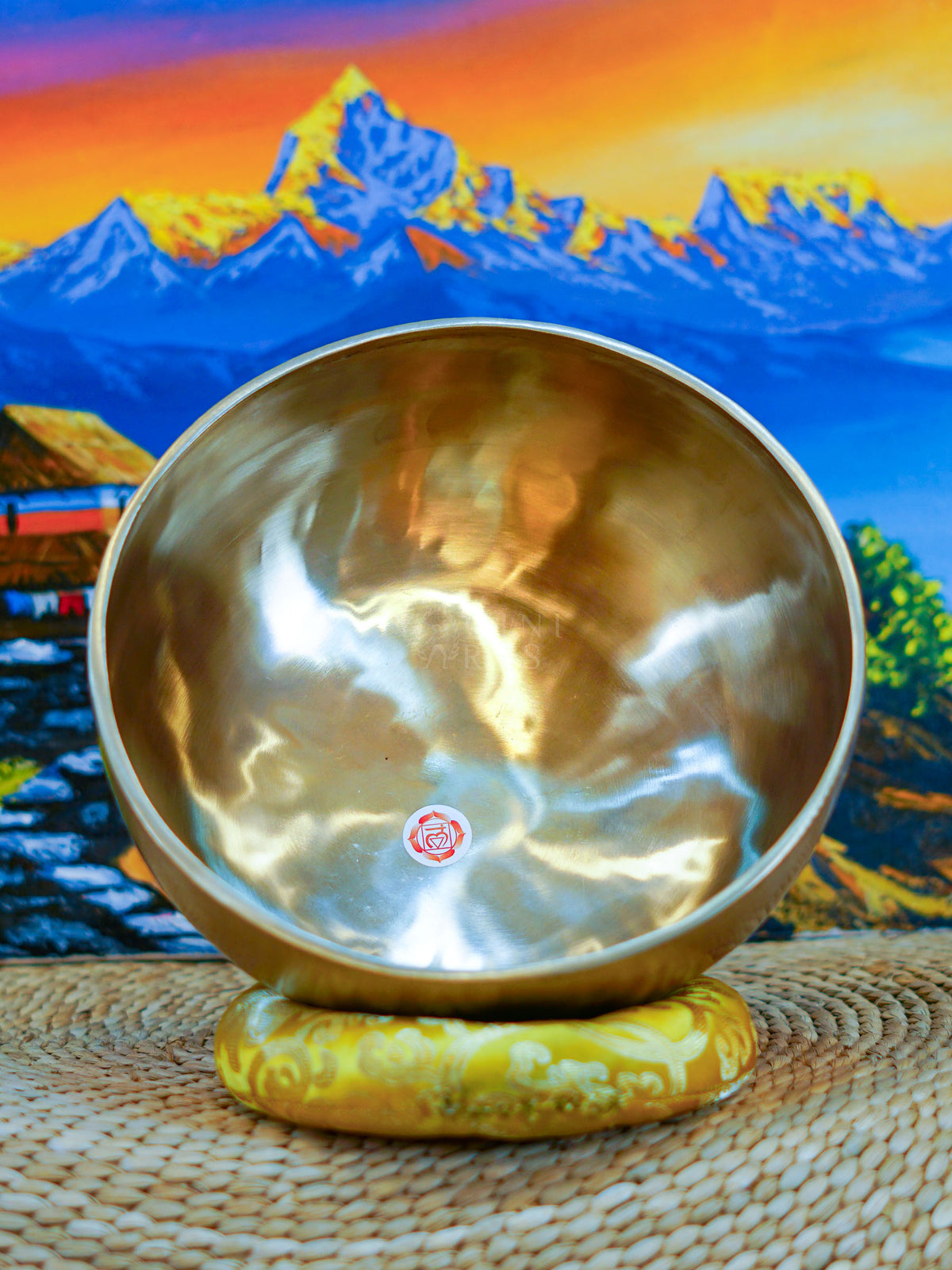 Seven handcrafted Himalayan singing bowls arranged together, showing graduated sizes, chakra symbols, and warm antique bronze-gold finishes.