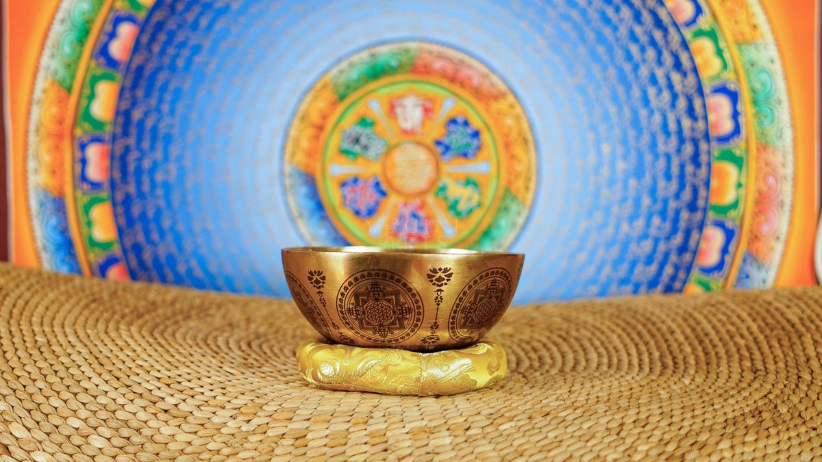 Chakra Mandala singing bowl with sacred geometry, meditation figure, and detailed engraved Buddhist-inspired artwork