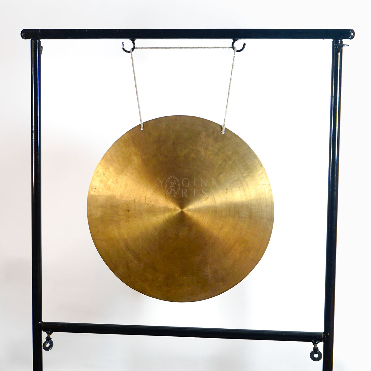 Front view of a large round Tibetan-style gong showing its warm brass-toned surface and radial handcrafted metal texture.