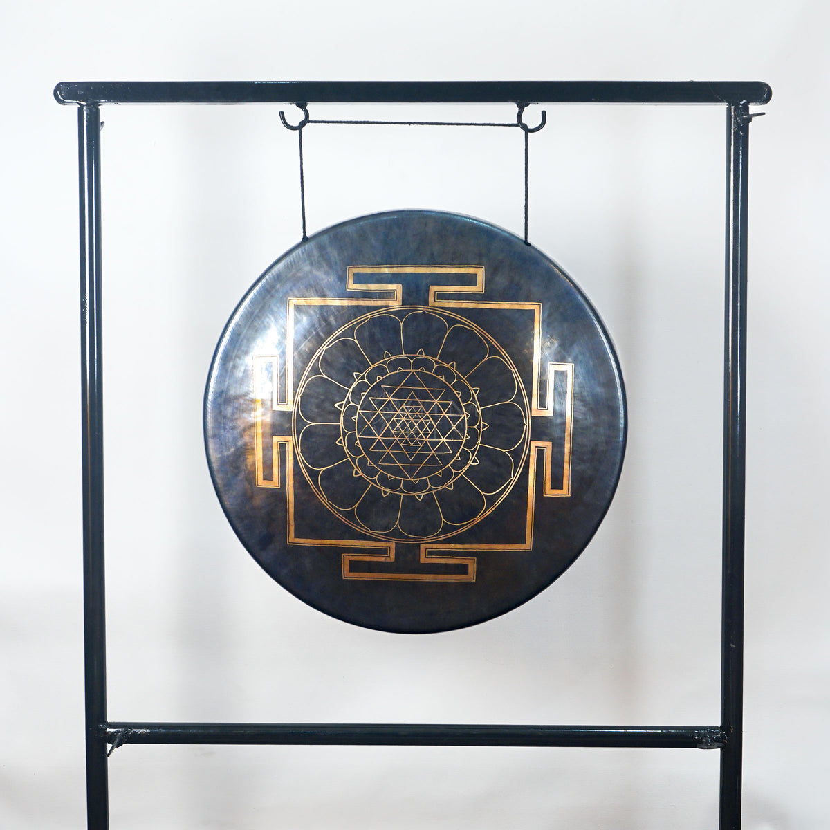 Front view of a Tibetan-style meditation gong featuring a gold sacred geometry mandala with lotus petals and four geometric gateways.