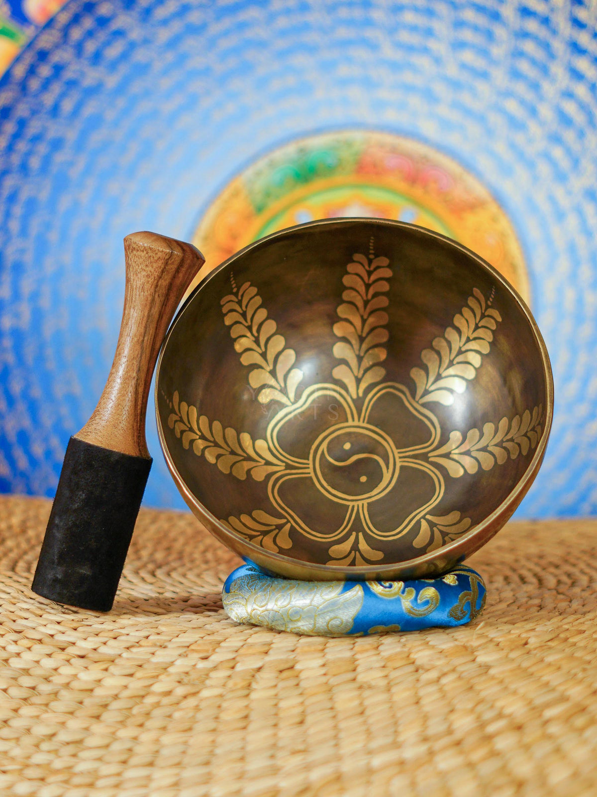 Handcrafted Yin Yang singing bowl from Nepal with floral engraving and bronze-gold finish for meditation and sound practice.