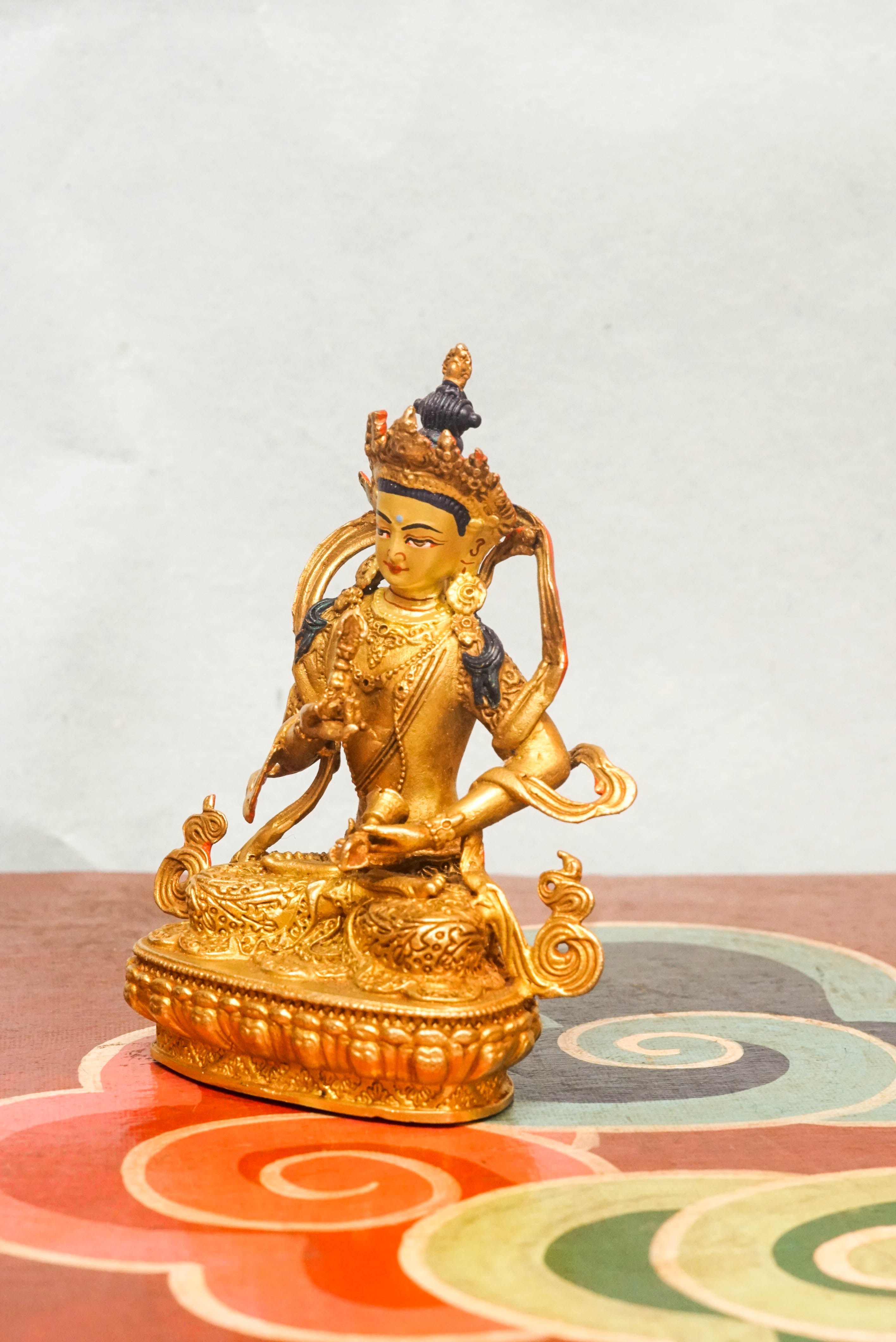Invite purity and spiritual cleansing with this handcrafted Vajrasattva statue. Depicted in the diamond posture, holding a vajra and bell symbolizing wisdom and compassion. This statue inspires inner clarity and spiritual renewal