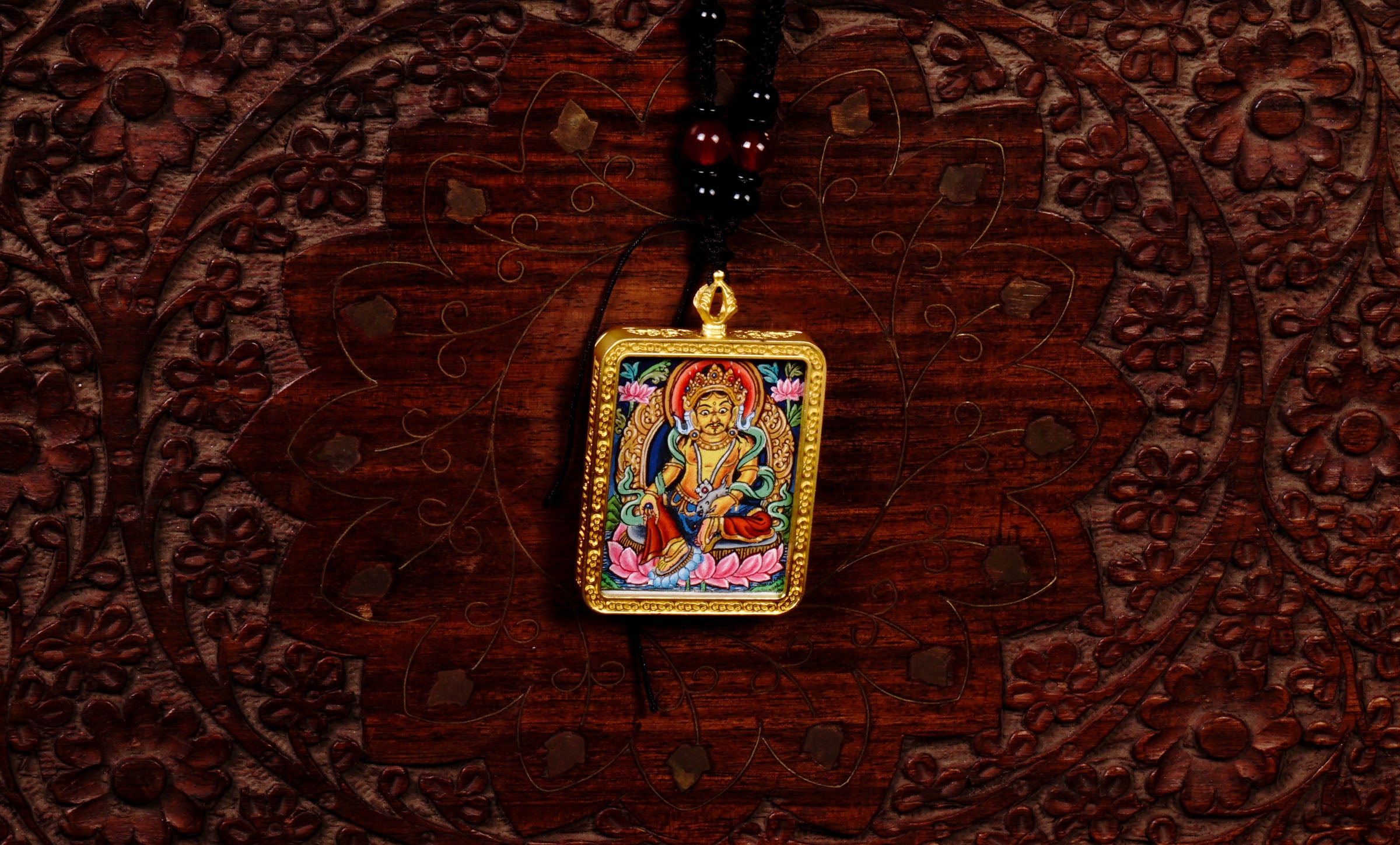 Hand-painted Yellow Zambala miniature Thangka pendant in gold-accented copper Ghau locket with black beaded cord.