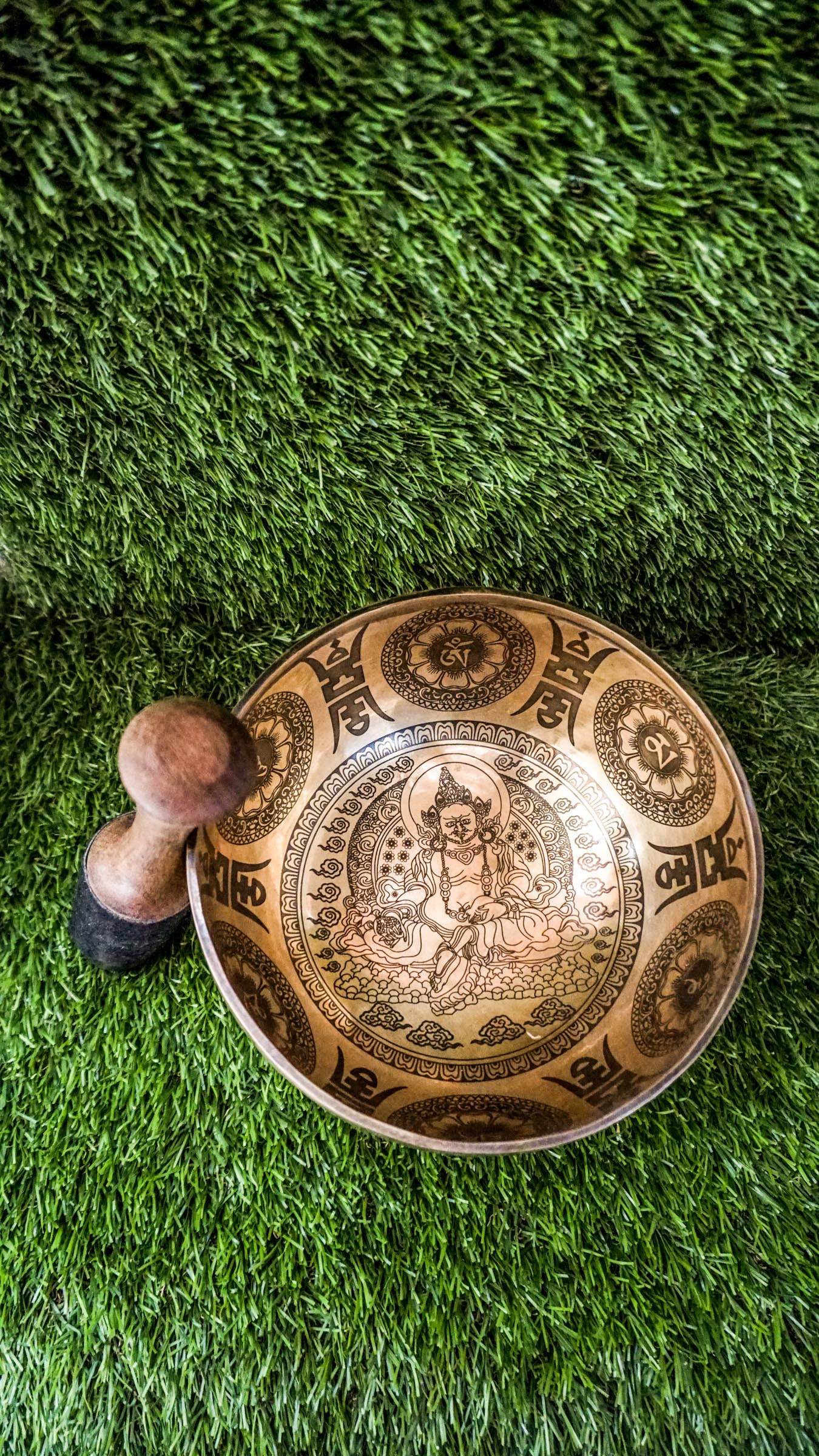 The Zambala Singing Bowl features Zambala, the deity of wealth and abundance, at its center with a radiant flower mandala. The outside is decorated with detailed mini mandalas and the Om Mani Padme Hum mantra, promoting prosperity and compassion. It produces rich, uplifting tones that support manifestation and spiritual grounding.