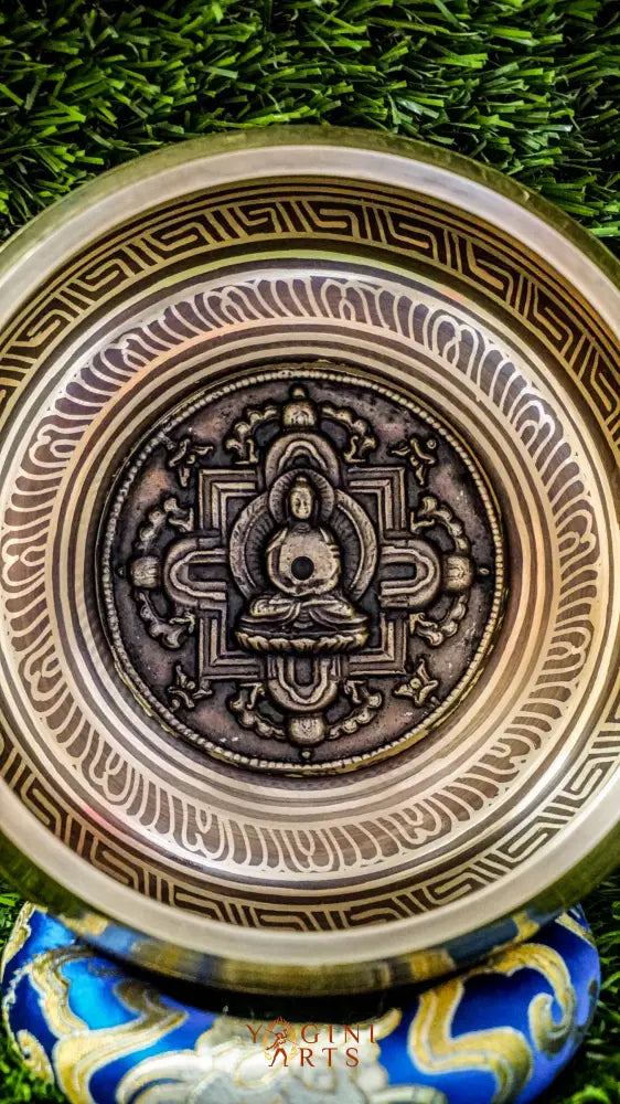 The Buddha Mandala Bronze Singing Bowl features a meditating Buddha inside a sacred mandala with the Om Mani Padme Hum mantra outside. Its soothing tones promote peace, focus, and spiritual balance and are perfect for meditation and grounding your space.