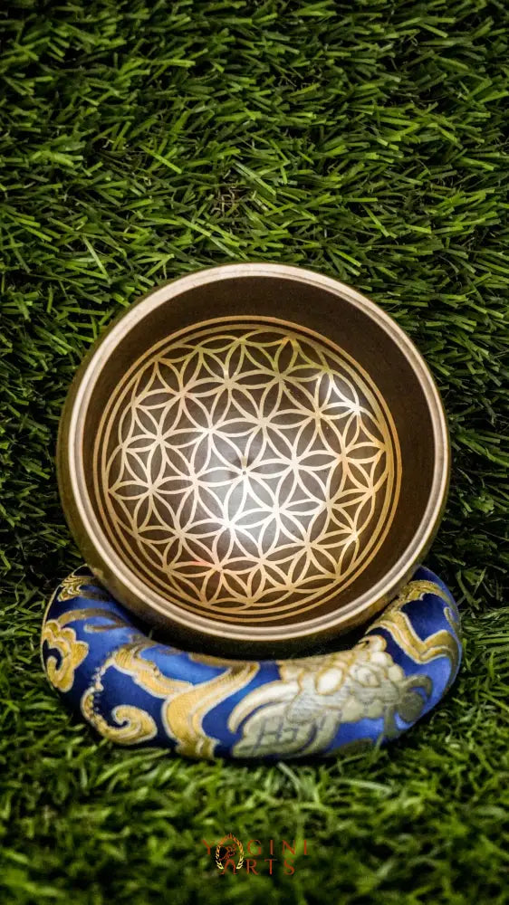 Invite harmony, balance, and positive energy with our handcrafted Flower of Life Singing Bowl. Featuring the sacred Flower of Life symbol inside and intricate geometric patterns outside, it represents unity and the cycle of life. Handmade by skilled artisans, this bowl produces clear, calming tones that support meditation, relaxation, and emotional balance. Includes a wooden mallet and silk cushion. Perfect for any meditation space or spiritual journey.
