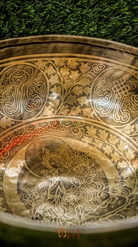 Invite compassion and healing into your space with our handcrafted Green Tara Singing Bowl. Featuring a detailed image of Green Tara inside, it symbolizes protection, care, and swift aid. The exterior is engraved with sacred patterns that amplify her blessings. Handmade by skilled artisans, this bowl produces clear, soothing tones that promote peace and focus. Includes a wooden mallet and silk cushion for easy use and care.
