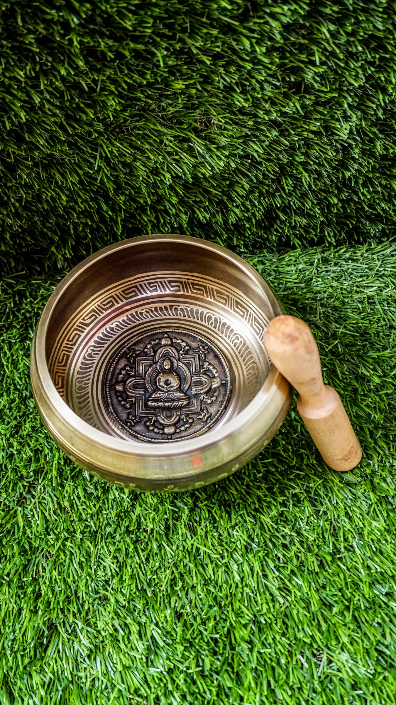 The Buddha Mandala Bronze Singing Bowl features a meditating Buddha inside a sacred mandala with the Om Mani Padme Hum mantra outside. Its soothing tones promote peace, focus, and spiritual balance and are perfect for meditation and grounding your space.