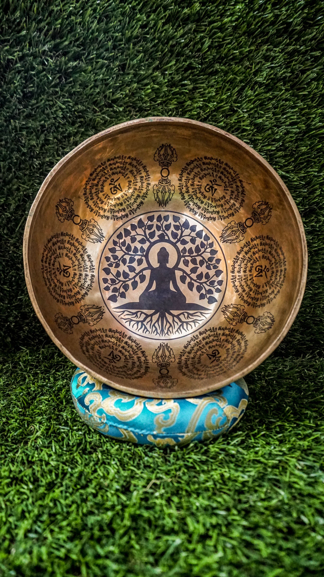 This handcrafted Buddha Tree Singing Bowl features a detailed Bodhi tree engraving, symbolizing enlightenment and spiritual resilience. Sacred Sanskrit mantras around the rim enhance its energy-cleansing power. Hand-hammered by Himalayan artisans, it produces deep, calming tones ideal for meditation, healing, and mindfulness. A perfect tool to ground your energy, raise your vibration, and deepen your spiritual practice.