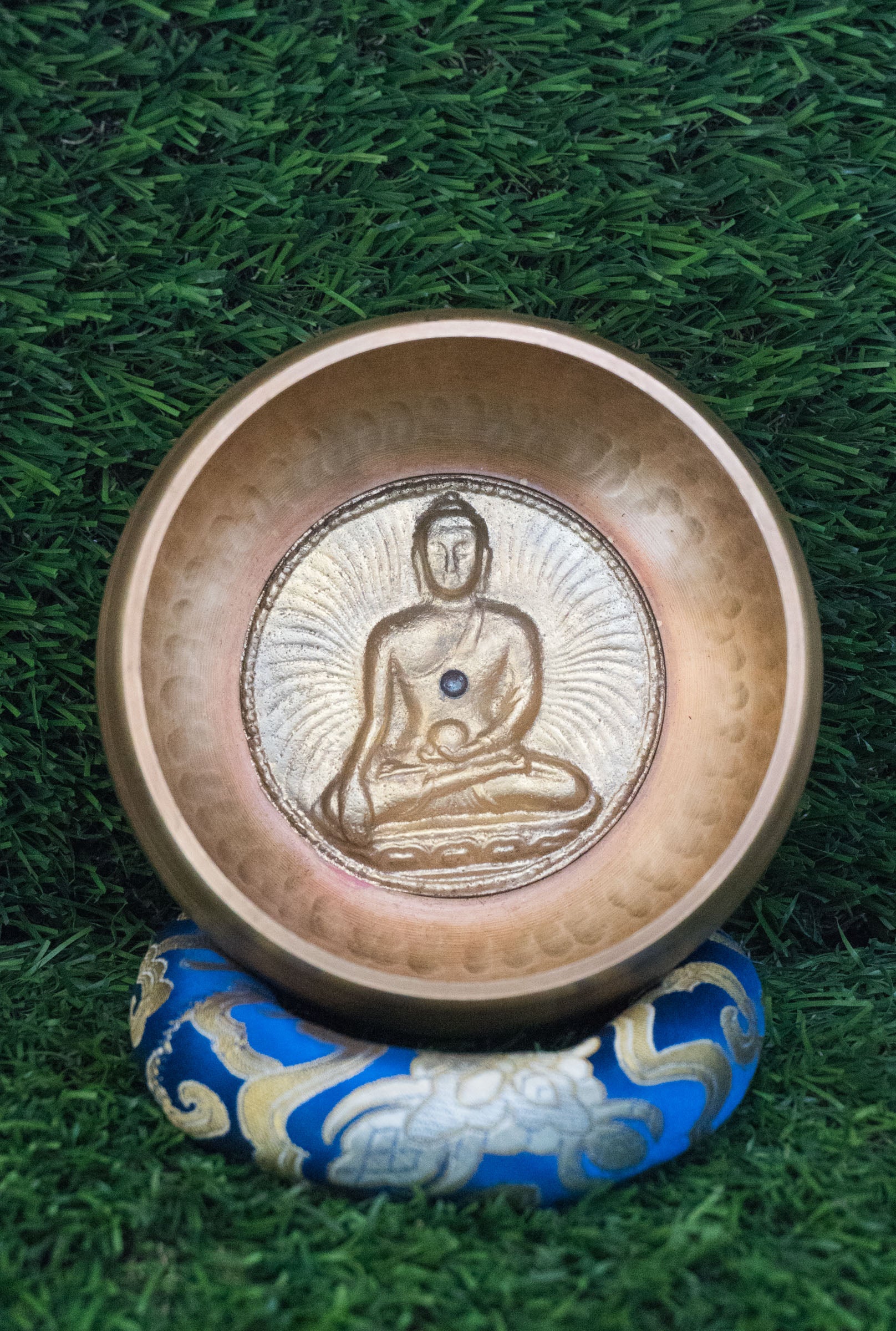 Invite mindfulness and calm with our handcrafted Dotted Buddha Singing Bowl. Featuring an engraved Buddha surrounded by a dotted mandala symbolizing stillness and spiritual balance, this bowl reminds you to stay present. Traditional mantras circle the rim, adding protection and spiritual energy. Handcrafted by skilled Himalayan artisans, it produces soothing tones that quiet the mind and support meditation, breathwork, and daily mindfulness practice.








