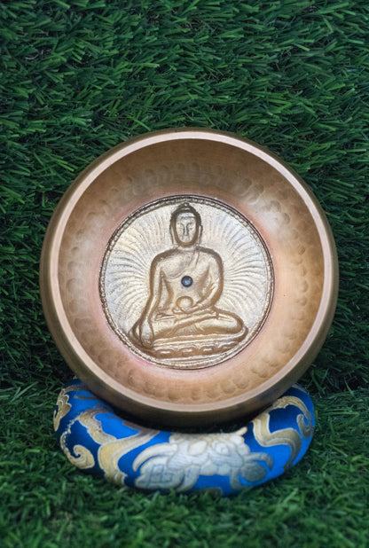 Invite mindfulness and calm with our handcrafted Dotted Buddha Singing Bowl. Featuring an engraved Buddha surrounded by a dotted mandala symbolizing stillness and spiritual balance, this bowl reminds you to stay present. Traditional mantras circle the rim, adding protection and spiritual energy. Handcrafted by skilled Himalayan artisans, it produces soothing tones that quiet the mind and support meditation, breathwork, and daily mindfulness practice.








