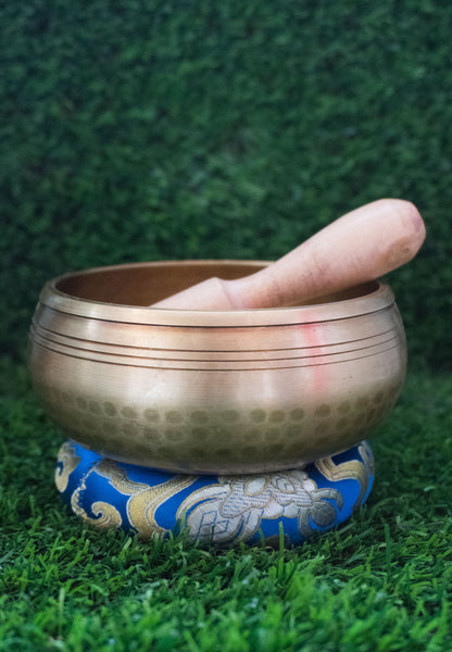 Invite mindfulness and calm with our handcrafted Dotted Buddha Singing Bowl. Featuring an engraved Buddha surrounded by a dotted mandala symbolizing stillness and spiritual balance, this bowl reminds you to stay present. Traditional mantras circle the rim, adding protection and spiritual energy. Handcrafted by skilled Himalayan artisans, it produces soothing tones that quiet the mind and support meditation, breathwork, and daily mindfulness practice.








