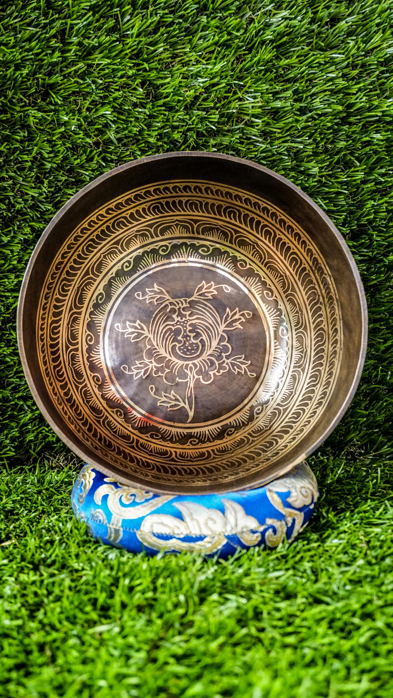 The Lotus Singing Bowl is a gentle reminder of inner peace and spiritual growth. A blooming lotus sits at its center, symbolizing purity and awakening. Around the bowl, each Om Mani Padme Hum syllable rests in a flower-like form, blending mantra and beauty. Its soft, steady tone supports stillness, clarity, and calm.