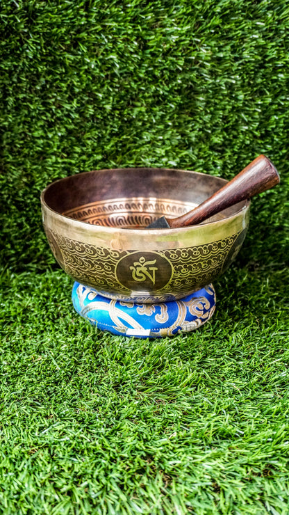 The Lotus Singing Bowl is a gentle reminder of inner peace and spiritual growth. A blooming lotus sits at its center, symbolizing purity and awakening. Around the bowl, each Om Mani Padme Hum syllable rests in a flower-like form, blending mantra and beauty. Its soft, steady tone supports stillness, clarity, and calm.