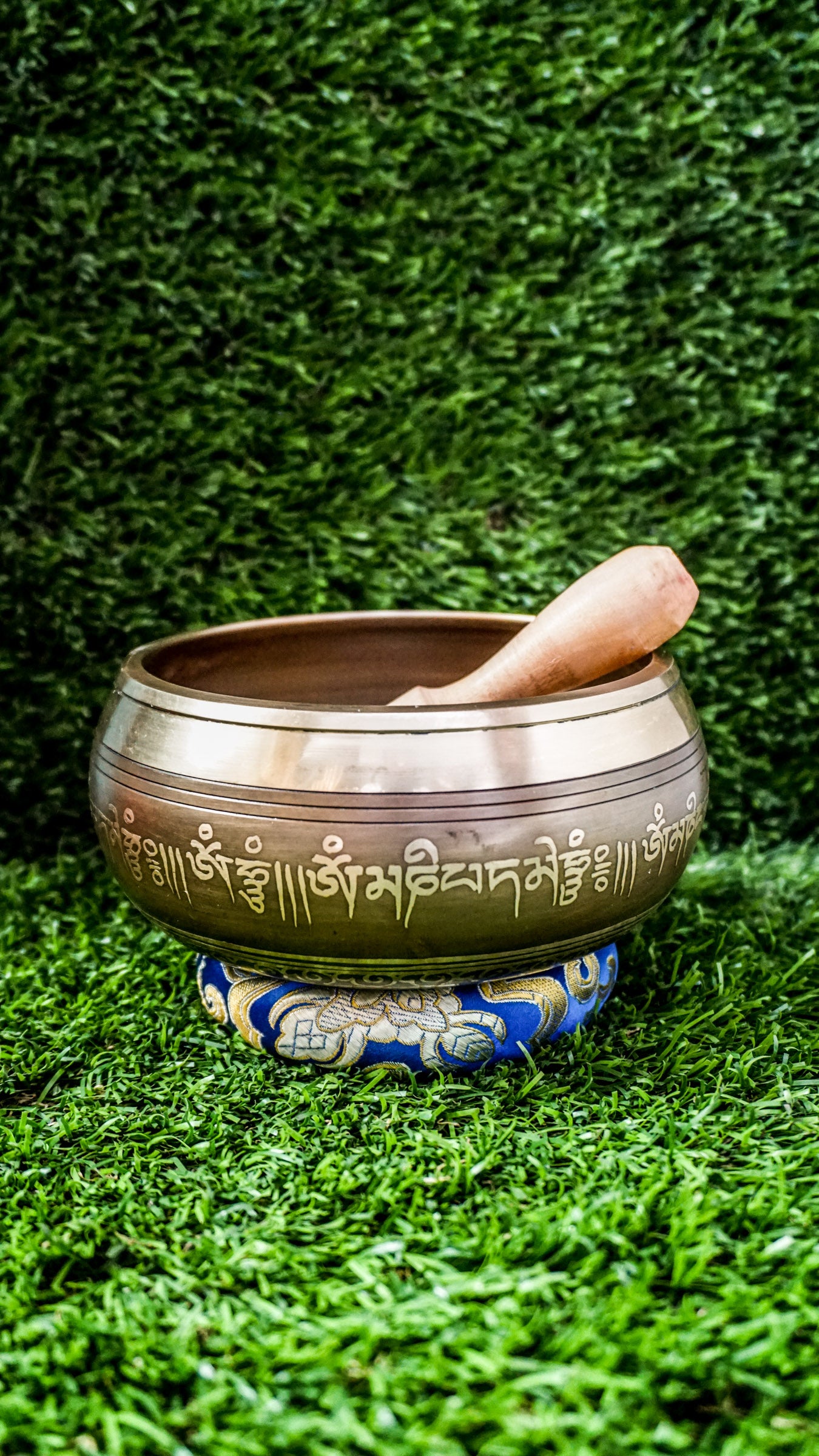The Om Singing Bowl features a carved Tibetan Om symbol inside and the Om Mani Padme Hum mantra outside. Its clear, calming tone supports meditation and peace. Includes mallet and cushion. Wipe gently and store dry.