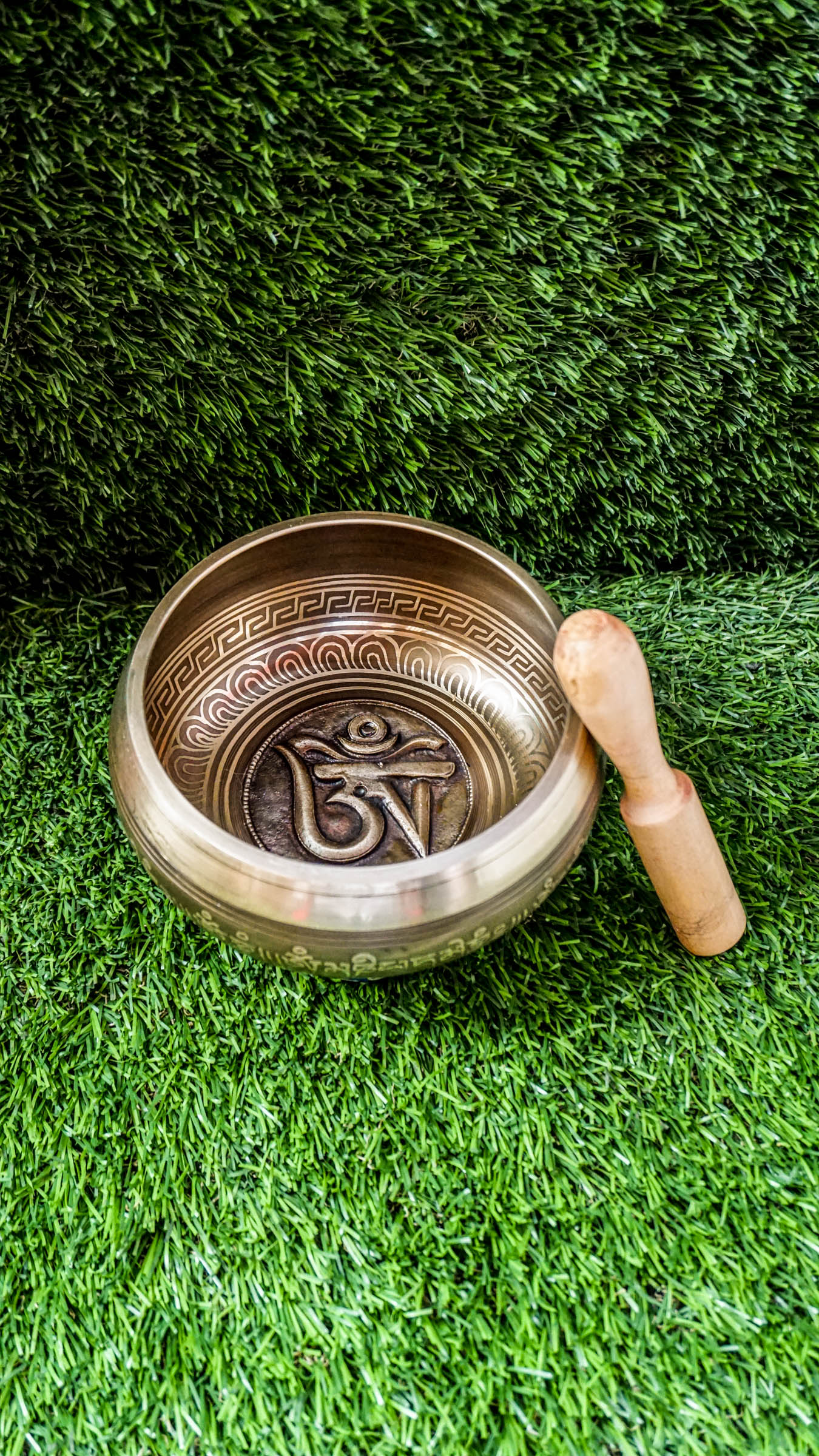 The Om Singing Bowl features a carved Tibetan Om symbol inside and the Om Mani Padme Hum mantra outside. Its clear, calming tone supports meditation and peace. Includes mallet and cushion. Wipe gently and store dry.