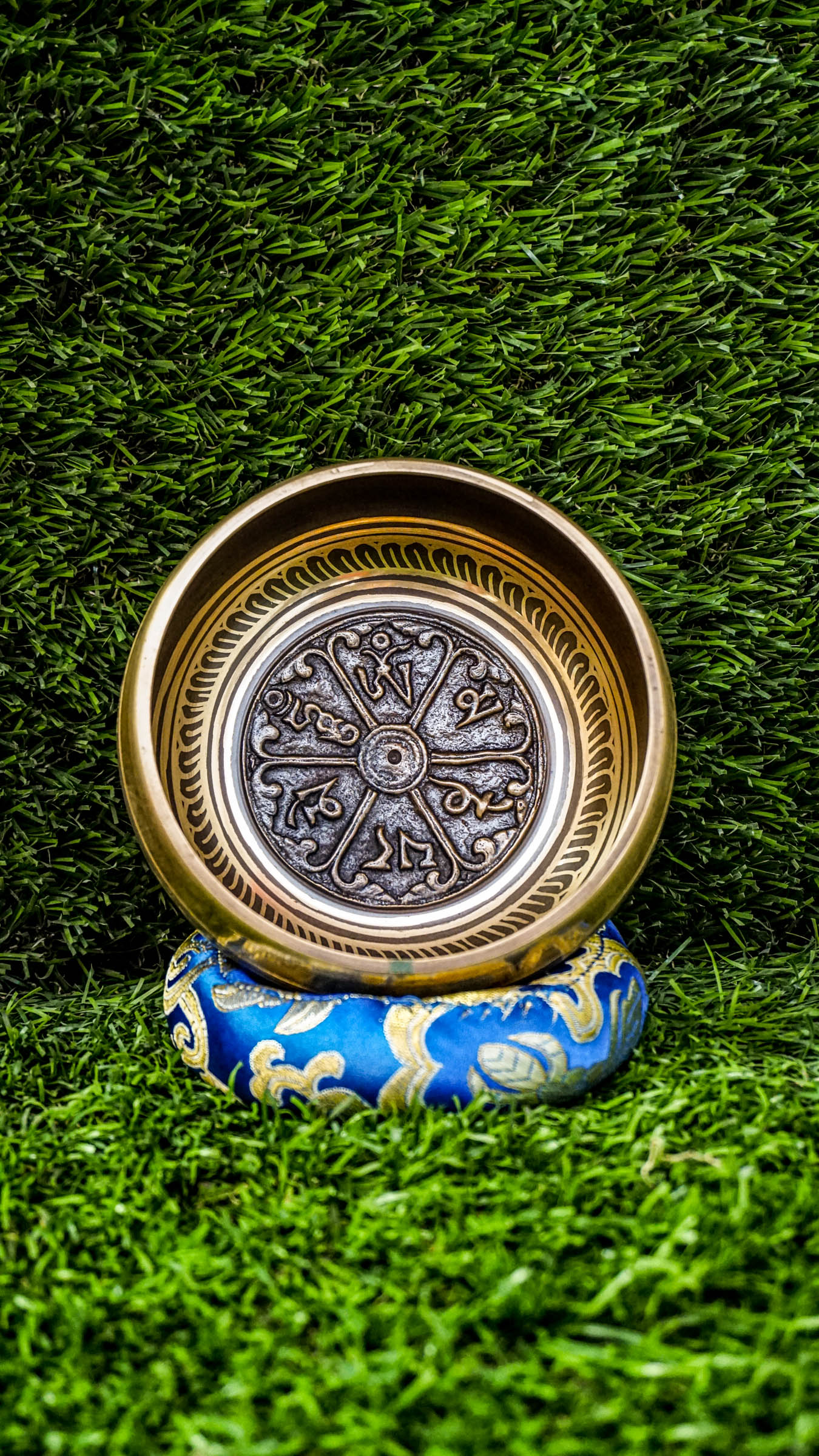 
This singing bowl has the Om Mani Padme Hum mantra carved inside on a mandala and around the outside. Its clear, steady tone supports meditation and calm. Comes with a wooden mallet and silk cushion. Wipe gently and store in a dry place.