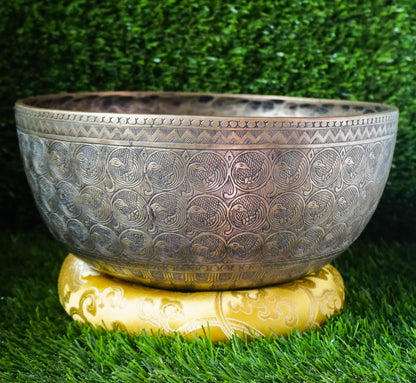 Semi-antique peacock carved singing bowl handcrafted in Nepal with detailed peacock motifs for meditation and healing.