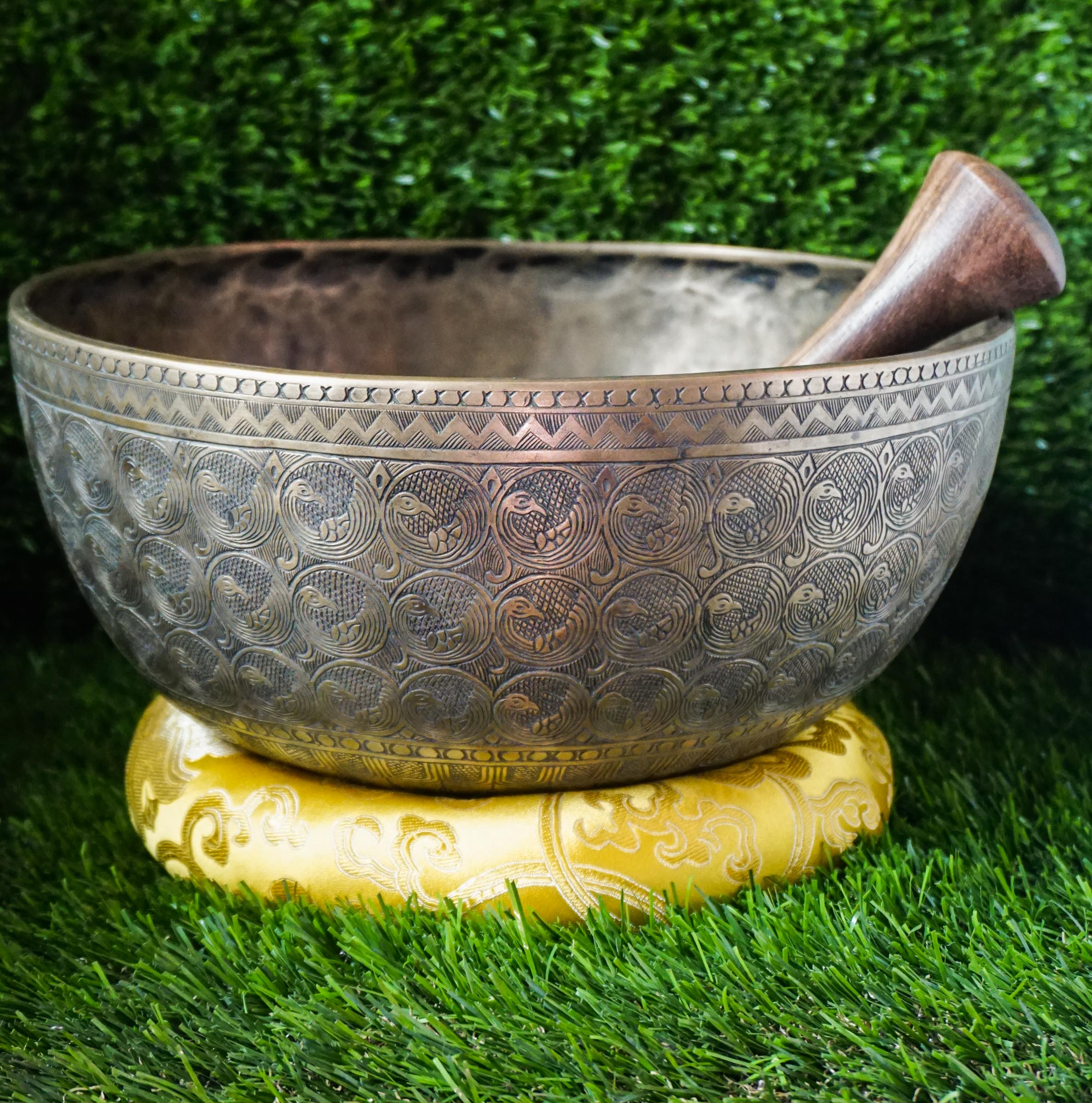 Semi-antique peacock carved singing bowl handcrafted in Nepal with detailed peacock motifs for meditation and healing.