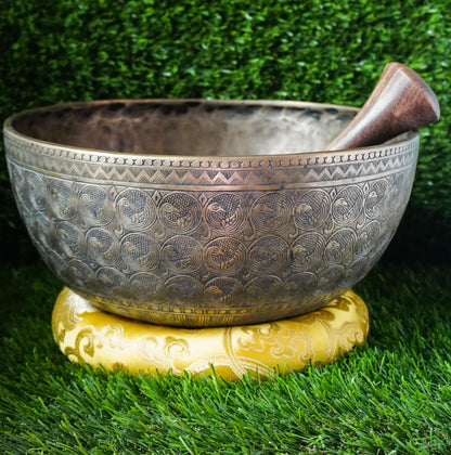 Semi-antique peacock carved singing bowl handcrafted in Nepal with detailed peacock motifs for meditation and healing.