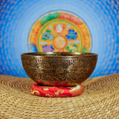 Semi antique floral engraved Tibetan singing bowl handcrafted in Nepal with detailed flower and foliage design