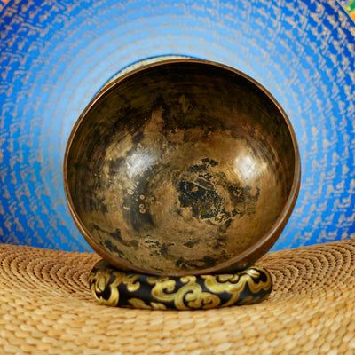 Semi antique floral engraved Tibetan singing bowl handcrafted in Nepal with detailed botanical patterns and antique bronze finish