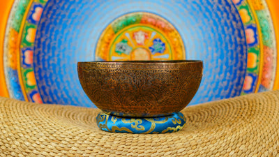 Semi antique floral engraved singing bowl handcrafted in Nepal with intricate flowers and leaf patterns in an antique bronze finish