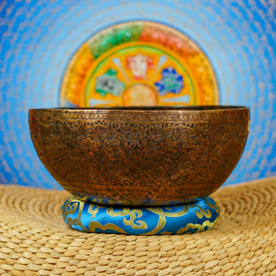 Semi antique floral engraved singing bowl handcrafted in Nepal with intricate flowers and leaf patterns in an antique bronze finish