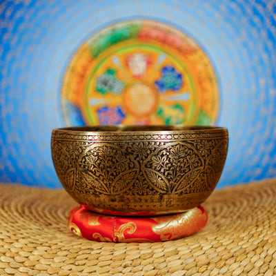 Semi antique floral engraved singing bowl handcrafted in Nepal with intricate flower and leaf patterns and an antique bronze finish