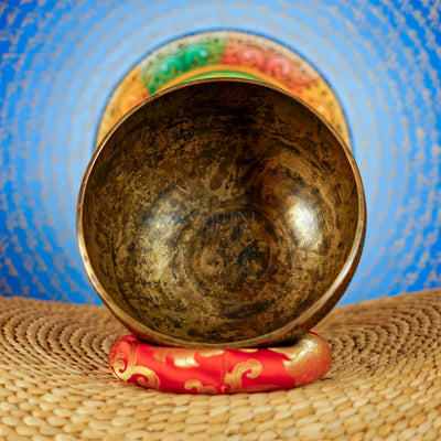 Semi antique floral engraved singing bowl with intricate flower and leaf patterns and an antique bronze finish
