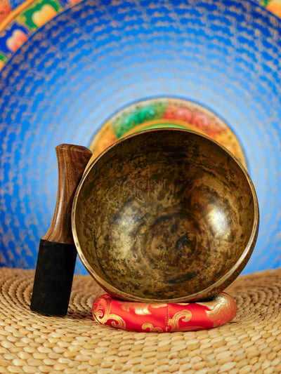 Semi antique floral engraved singing bowl with intricate flower and leaf patterns and an antique bronze finish