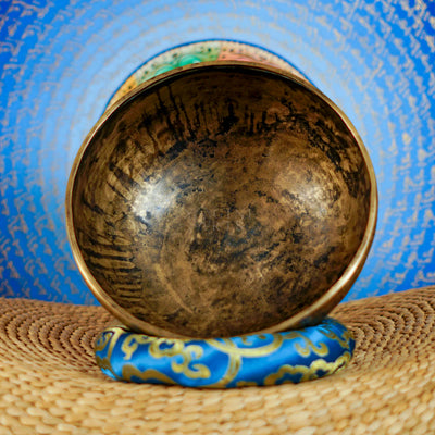 Semi antique singing bowl with intricate floral engraved panels and traditional aged bronze finish