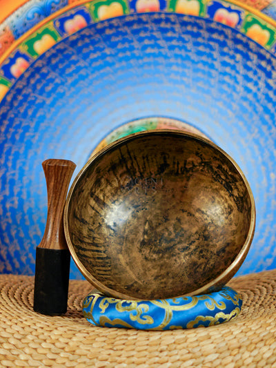 Semi antique singing bowl with intricate floral engraved panels and traditional aged bronze finish