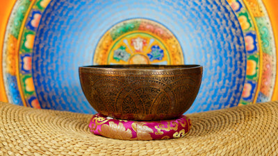 Semi antique singing bowl with intricate arch and floral engraved patterns in an aged bronze finish