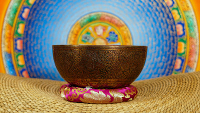Semi antique singing bowl with intricate star-shaped floral engraving and traditional botanical patterns