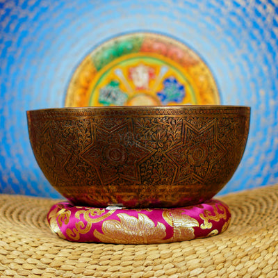 Semi antique singing bowl with intricate star-shaped floral engraving and traditional botanical patterns