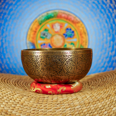 Semi antique singing bowl with circular floral and leaf engraving, traditional Himalayan design