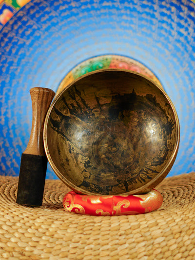 Semi antique singing bowl with circular floral and leaf engraving, traditional Himalayan design