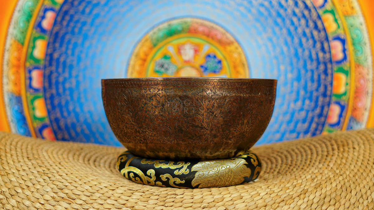 Semi antique singing bowl with intricate floral and leaf engraving, traditional Himalayan design