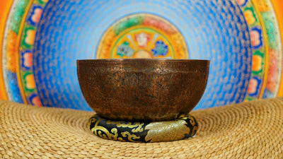 Semi antique singing bowl with intricate floral and leaf engraving, traditional Himalayan design