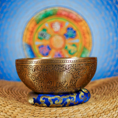Semi antique singing bowl with hand-engraved bird and floral patterns, traditional Himalayan design