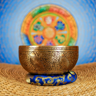 Semi antique singing bowl with engraved bird and floral design, handcrafted in Nepal