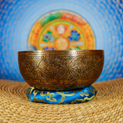 Semi antique handmade singing bowl with intricate geometric floral and leaf engraving on aged bronze metal